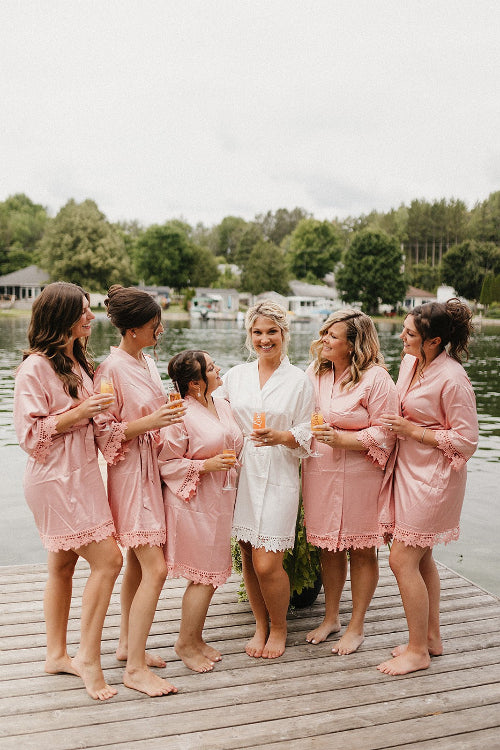 Bridal party wearing Aurora satin dusty rose robes on boat dock. 431 the wedding company. 