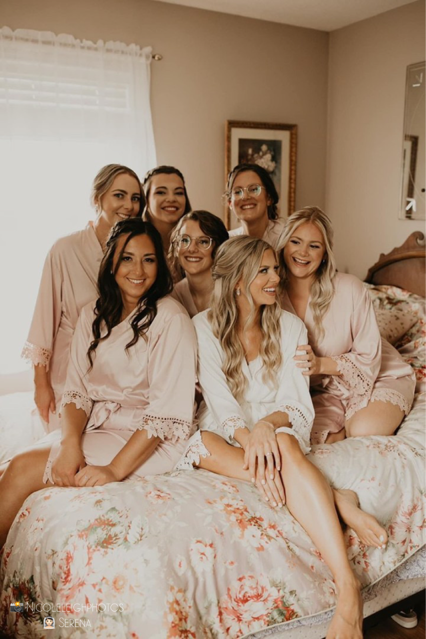 Bridal party wearing Aurora satin robes in white and blush