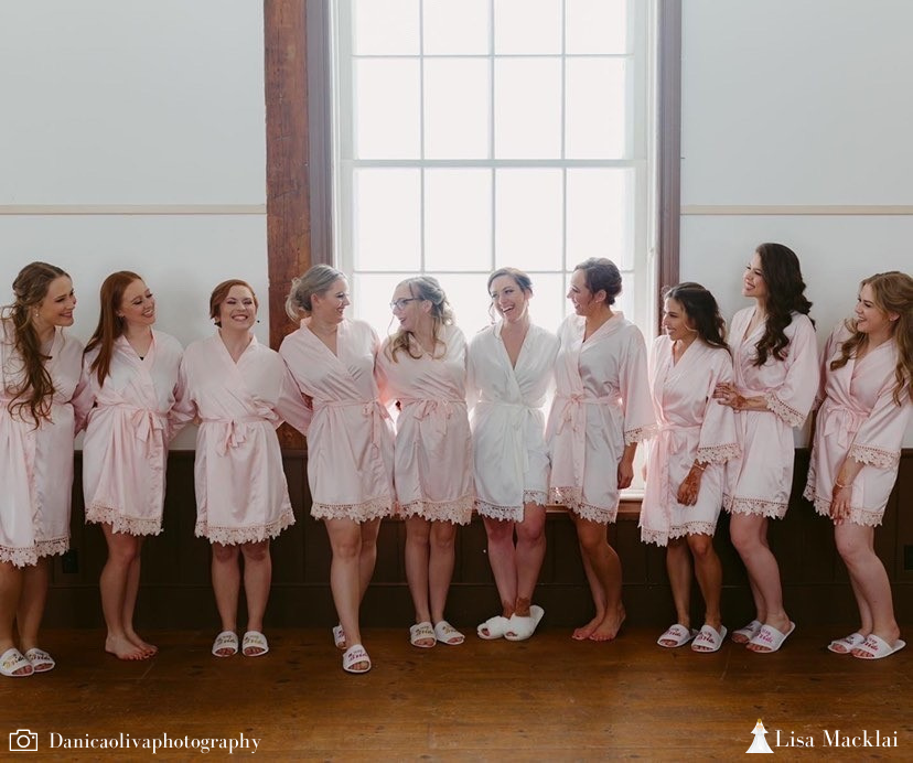 Bridal party wearing Aurora satin robes in white and blush. 431 the wedding company customer photo