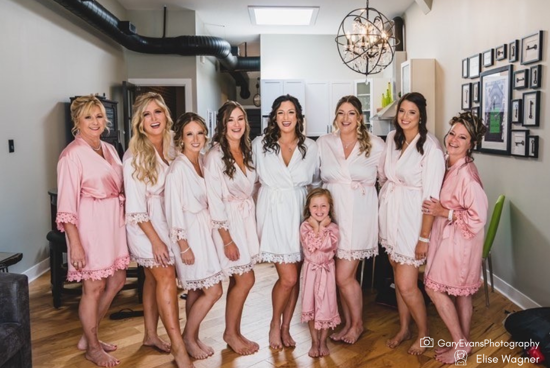 Bridal party wearing Aurora satin robes dusty rose and bride in white. 431 the wedding company robes 
