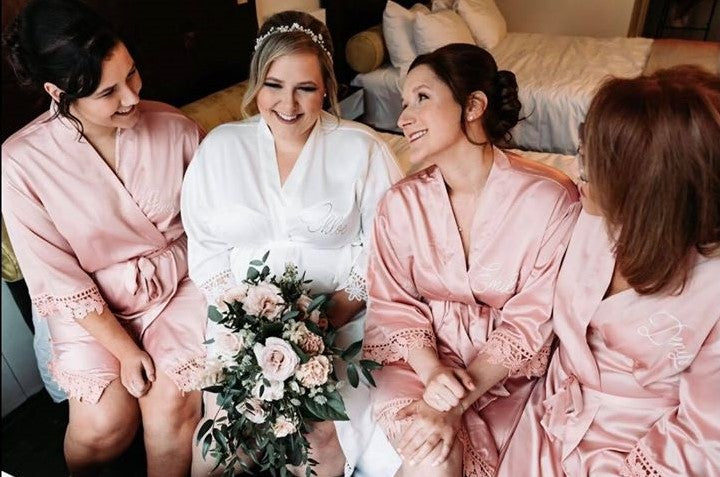 Bridal party wearing Aurora satin robes in white and dusty rose. 431 the wedding company customer. 