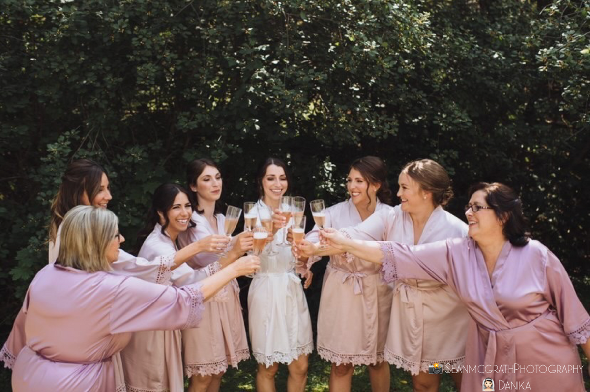 Bridal party wearing Aurora satin light mauve and white robes. 431 the wedding company customer