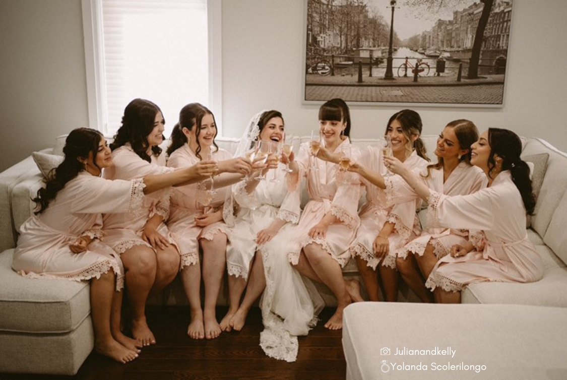Bridal party wearing Aurora satin robes in white and blush. 431 the wedding company customer 