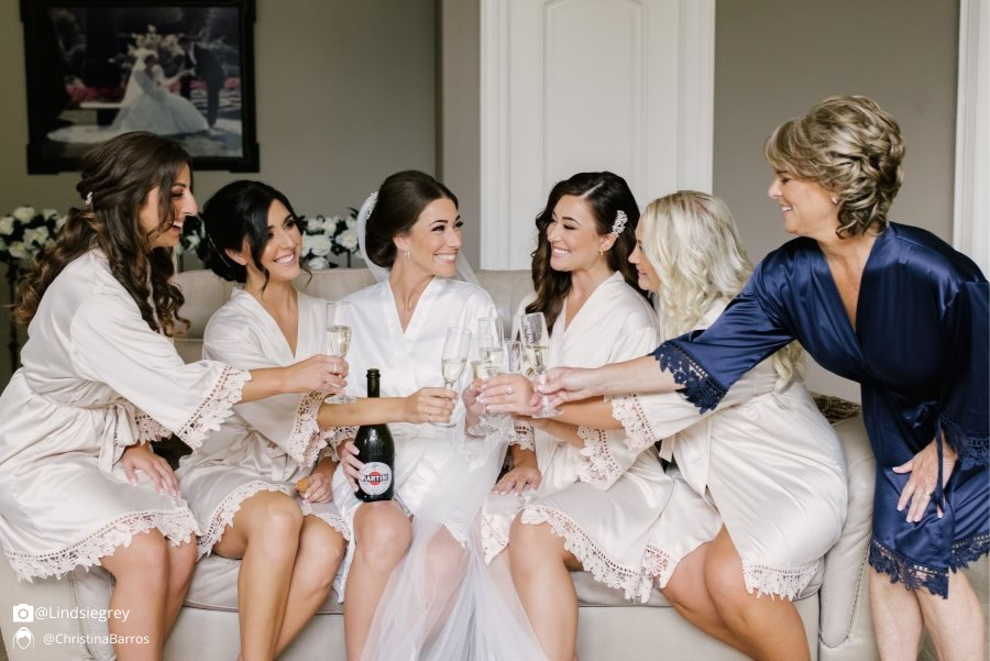 Bridal party group photo featuring the white champagne and navy blue satin robes