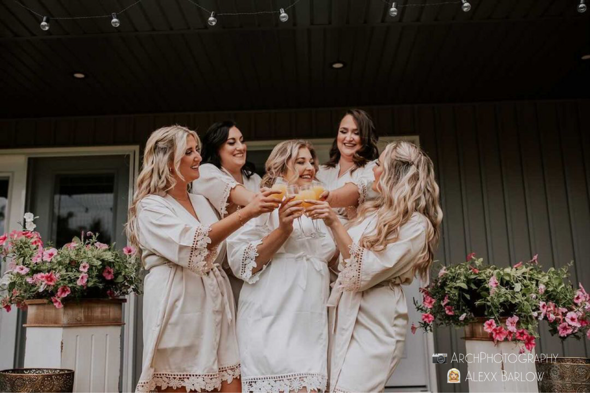 Bridal party group photo featuring the white and champagne aurora satin robes